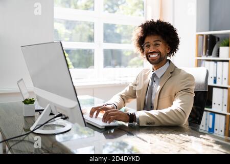 African American Business Man Using Computer In Office Stock Photo