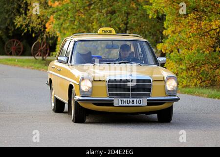 Yellow Taxi Mercedes-Benz W123 220D on small street. The W123, popular in taxi use, was manufactured in 1976-1986. Salo, Finland. October 3, 2020. Stock Photo