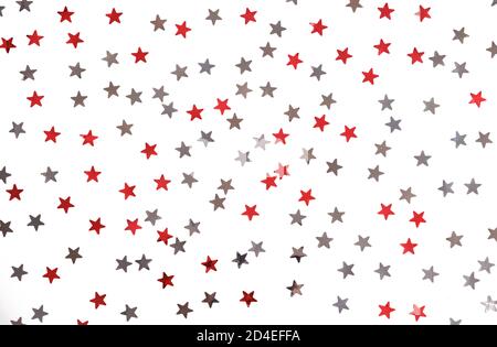 Red and silver stars glitter on a white isolated background. Stock Photo