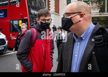 Benjamin Clark (left), 18, of Wilton Crescent, Hertford, and his father, Andrew Clark (right), exit Westminster Magistrates' Court in London, where Benjamin was charged with criminal damage to the Sir Winston Churchill statue in Parliament Square on September 10, the final day of ten days of Extinction Rebellion protests in the capital and admitted causing £1,642.03 worth of damage to the statue and spraying the word 'racist' in chalk paint, but denied causing all the damage to the statue done on the day. Deputy Chief Magistrate Tan Ikram handed down a £200 fine and ordered Clark to pay £1,200 Stock Photo