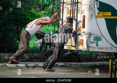 Dehradun, Uttarakhand/India-September 12 2020:Two men pushing bus in Corona pandemic condition. Stock Photo