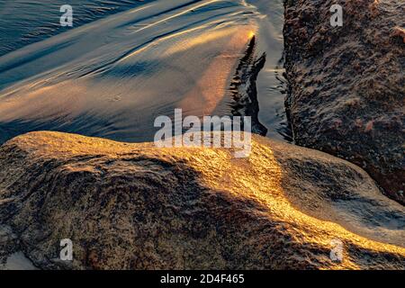 Wet sand and rocks detail, Narragansett Beach, RI USA Stock Photo