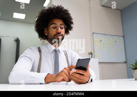 African Man Holding Smartphone Or Mobile Phone Stock Photo
