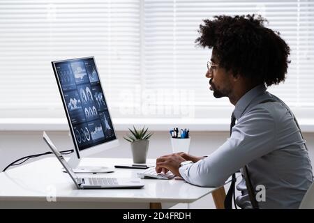 Business Data Analyst Using Computer. African American Advisor Stock Photo