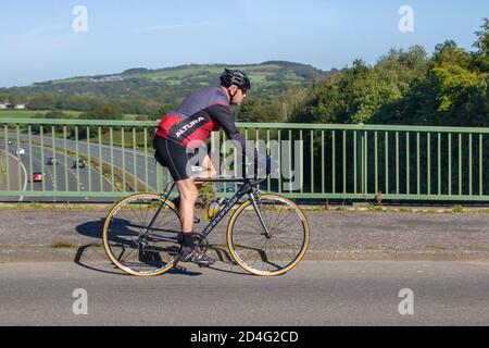 Male cyclist riding Cannondale carbon fibre sports road bike on