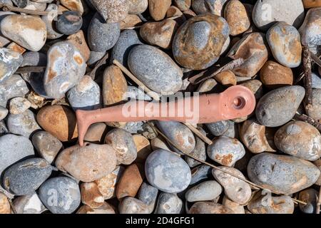 plastic waste on a pebble beach Stock Photo