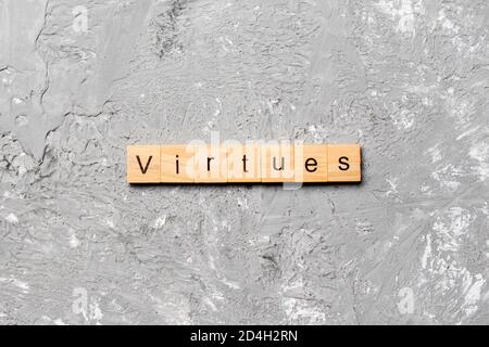 virtues word written on wood block. virtues text on cement table for your desing, concept. Stock Photo