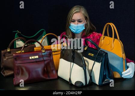 London, UK. 09th Oct, 2020. Part of the collection of 13 designer handbags (ests £250-3000) owned by the international best-selling novelist, Barbara Taylor Bradford OBE and a Pink Fantasy Tweed Jacket, Chanel, c. 1991, est £ 500 - 800 - Preview of Bonhams' Designer Handbags and Fashion Sale in Knightsbridge. Credit: Guy Bell/Alamy Live News Stock Photo