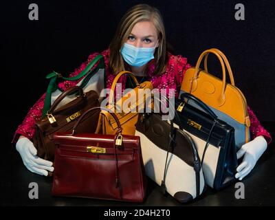 London, UK. 09th Oct, 2020. Part of the collection of 13 designer handbags (ests £250-3000) owned by the international best-selling novelist, Barbara Taylor Bradford OBE and a Pink Fantasy Tweed Jacket, Chanel, c. 1991, est £ 500 - 800 - Preview of Bonhams' Designer Handbags and Fashion Sale in Knightsbridge. Credit: Guy Bell/Alamy Live News Stock Photo