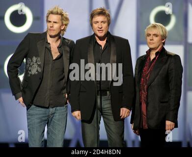 Members of the British band Duran Duran (L-R) John Taylor, Simon LeBon and Nick Rhodes, introduce a performance at the 2004 Billboard Music Awards at the MGM Grand Garden Arena in Las Vegas December 8, 2004. [R&B singer Usher, who scored the biggest album of the year and four No. 1 singles, picked up 11 trophies at the Billboard Music Awards in Las Vegas on Wednesday, with Alicia Keys, OutKast and Grammys frontrunner Kanye West also sharing in the spoils.]