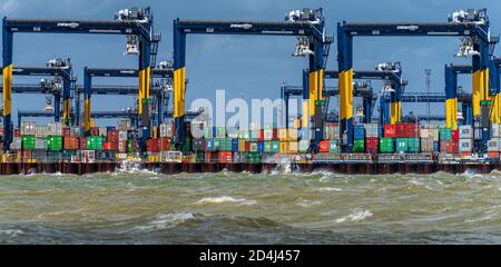 Stormy weather for British Trade - waves crash against Felixstowe Docks. The Port of Felixstowe is the UK's largest container port. Stock Photo
