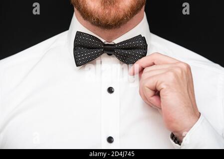 Redhead man with red beard dressed in black bowtie and white shirt Stock Photo