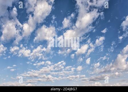 White  fluffy clouds in blue sky. Beautiful natural background with clouds Stock Photo