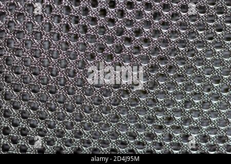 Abstract texture of black metal mesh with fine mesh, curved and deformed. Stock Photo