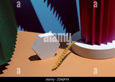 Composition of geometric shapes and colored fans made of cardboard. Concept. Stock Photo