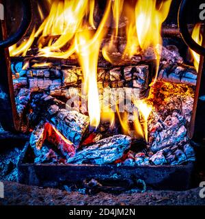 detail of the fire in the fireplace with glowing embers. Stock Photo