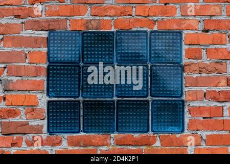 Glass window in a red brick wall, Red Brick wall for background or texture. Photo banner, space for text Stock Photo