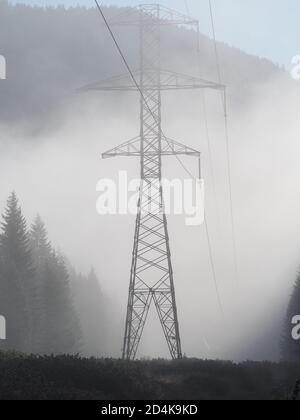 Transmission tower in fog Stock Photo