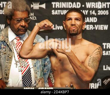 Middleweight boxer Winky Wright of St. Petersburg, Florida points to his muscles as promoter Don King looks on during an official weigh-in at the MGM Grand Garden Arena in Las Vegas, Nevada, May 13, 2005. Wright (48-3) takes on Felix 'Tito' Trinidad (42-1) of Cupey Alto, Puerto Rico in a 12-round WBC championship elimination bout at the arena May 14. Both fighters weighed the 160 lb. limit. REUTERS/Steve Marcus  SM/HK