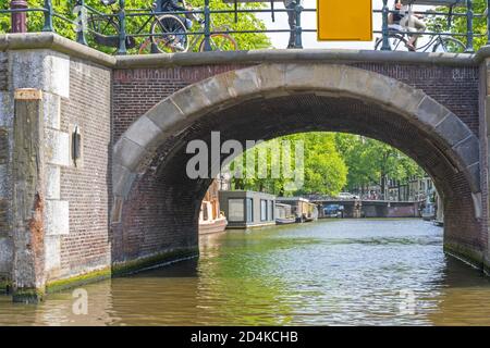 Arch Bridge Over Canal in Amsterdam Netherlands Stock Photo