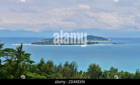 View of the two tiny islands Cousin and Cousine from the north of Praslin island, Seychelles with tropical vegetation in front. Main island Mahe. Stock Photo