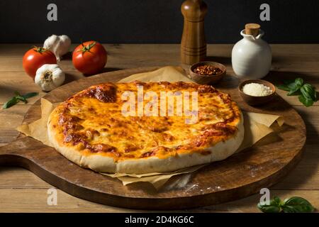 Preparing Homemade Uncooked Cheese PIzza with Sauce and Dough Stock Photo