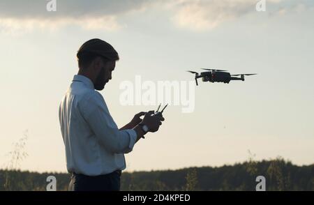 Man holding controller navigating quadcopter Stock Photo