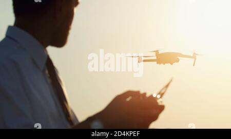 Male holding controller operating drone Stock Photo