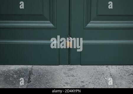 master key lock on green wooden door Stock Photo