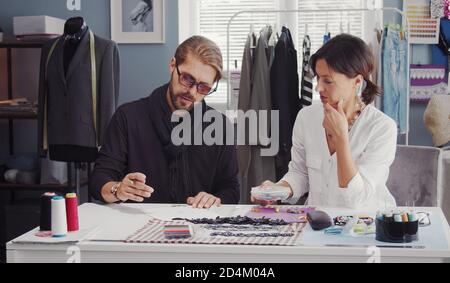 Two fashion designers discussing sketch Stock Photo