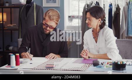 Two fashion designers drawing sketch Stock Photo