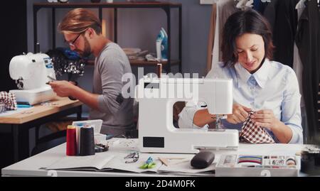 Two tailors working sewing workshop Stock Photo