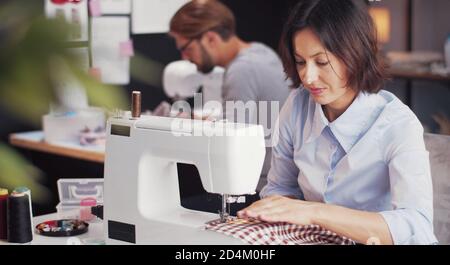 Seamstresses working on sewing machines Stock Photo
