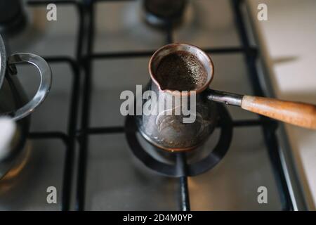 https://l450v.alamy.com/450v/2d4m0yp/high-angle-shot-of-coffee-is-brewed-in-a-copper-turk-on-the-gas-stove-2d4m0yp.jpg