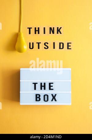 Think outside the box message box with light bulb Stock Photo