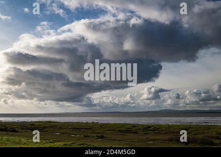 An autumnal image of a weather front over Morecambe bay, stretching from Bolton Le Sands to Walney Island, Lancashire, England. 07 October 2020 Stock Photo