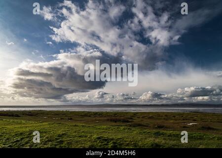 An autumnal image of a weather front over Morecambe bay, stretching from Bolton Le Sands to Walney Island, Lancashire, England. 07 October 2020 Stock Photo