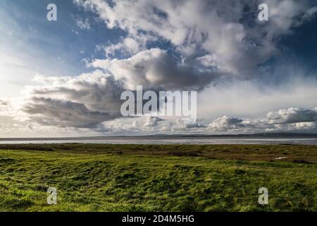 An autumnal image of a weather front over Morecambe bay, stretching from Bolton Le Sands to Walney Island, Lancashire, England. 07 October 2020 Stock Photo