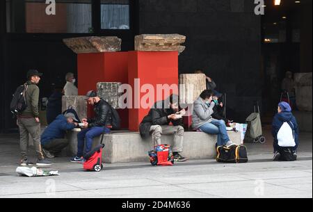 Cologne Germany 2020 Homeless and poor people eating food provided by  Jutta's soup kitchen outside the Roman-Germanic Museum in Koln.  Verteilung v Stock Photo