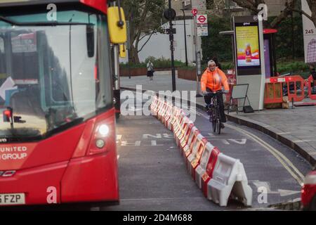 London, UK. 09th Oct, 2020. Cycle lanes bring about chaos and gridlock at Hammersmith Broadway causing long tailbacks as bus lanes are converted to cycle usage although not all cyclists choose to use their lanes. Credit: Peter Hogan/Alamy Live News Stock Photo