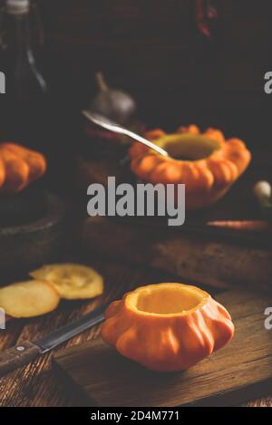 Preparing yellow pattypan squash for stuffing Stock Photo
