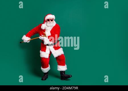Full length body size view of his he nice attractive handsome cheery Santa holding in hand cane having fun dancing rest celebratory festive day Stock Photo