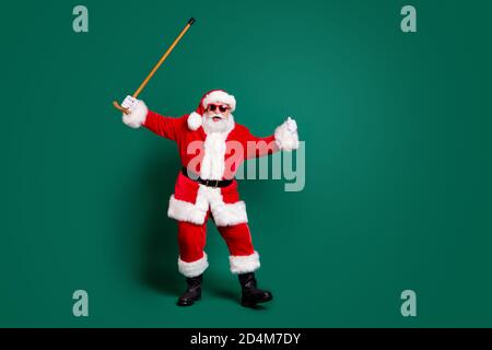 Full length body size view of his he nice attractive cheerful cheery glad funky Santa dancing with cane having fun celebration festive day fooling Stock Photo