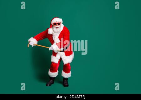 Full length body size view of his he nice attractive cheerful cheery childish funky Santa father dancing with cane having fun celebratory festive day Stock Photo
