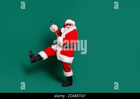 Full length body size view of his he nice attractive bearded cheerful cheery positive funky funny childish Santa father dancing with cane having fun Stock Photo
