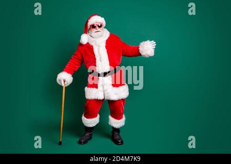 Full length body size view of his he nice attractive cheerful funny Santa father holding in hand wood stick cane dancing having fun walking isolated Stock Photo