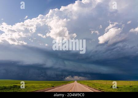 Scenic South Dakota landscape with a road and dark storm clouds approaching over the plains near Philip Stock Photo