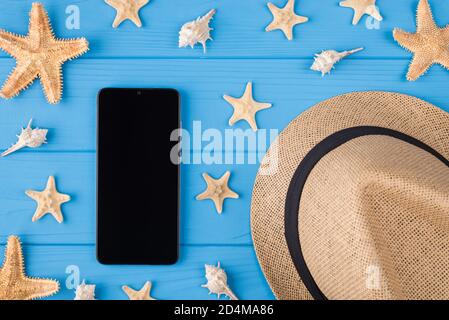 Top above overhead close-up view photo of digital telephone device with empty touchscreen seashell starfish sunhat on bright color background Stock Photo