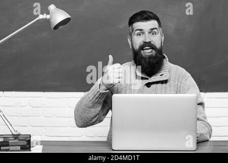 Student Studying Hard Exam. Bearded tutor near chalkboard. Bearded teacher in education class near chalkboard. Stock Photo