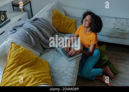 african american lady working on computer and laughing. Stock Photo